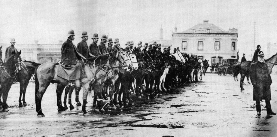 Source 14.6 Mounted police troopers in Melbourne in 1893 await the approach of unemployed workers marching to protest against the evictions of families unable to pay their rent during the 1890s Depression.